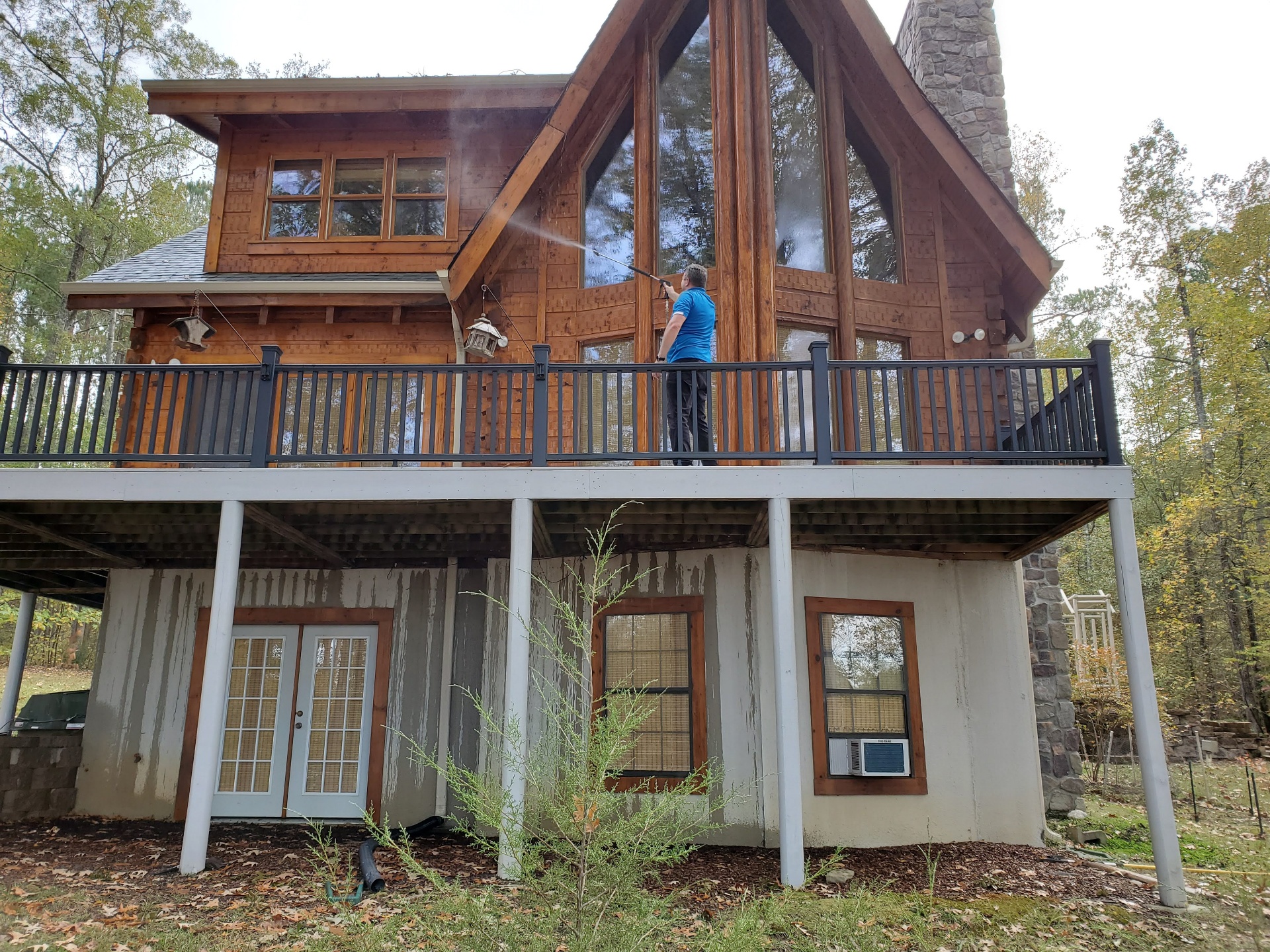Soft-wash roof cleaning on a home by Clean The Castle